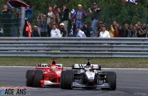 Hakkinen stuns Schumacher with three-wide pass for fourth win
